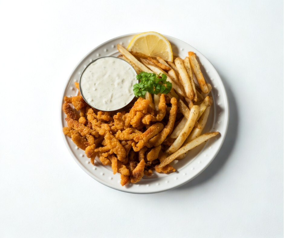 Golden fried clam strips served with tartar sauce and lemon